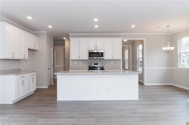 kitchen featuring white cabinetry, crown molding, baseboards, and stainless steel appliances