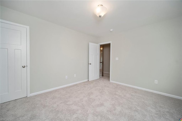 unfurnished bedroom with carpet floors and baseboards