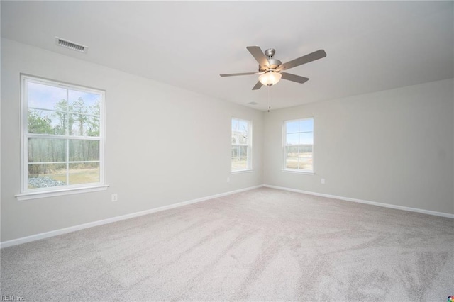 empty room featuring ceiling fan, baseboards, carpet flooring, and visible vents