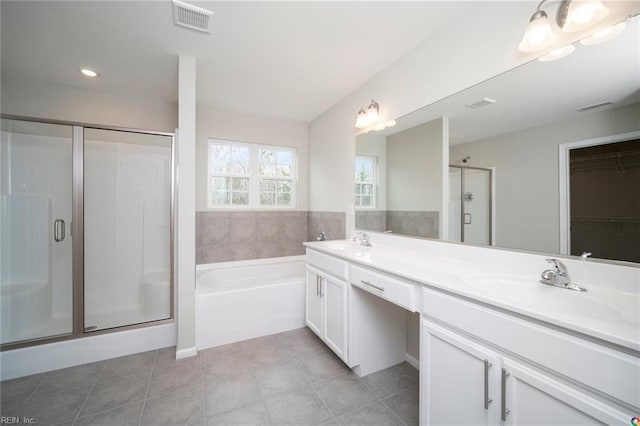full bath with a shower stall, visible vents, and a sink