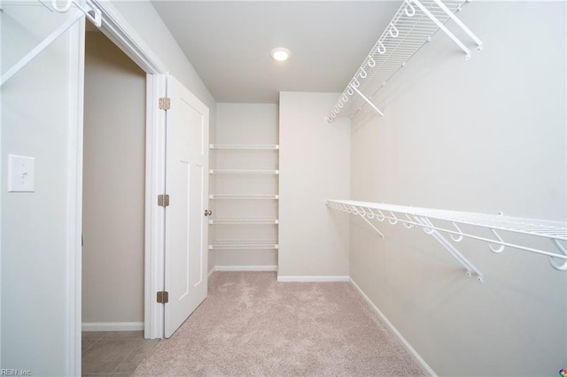 walk in closet with carpet floors