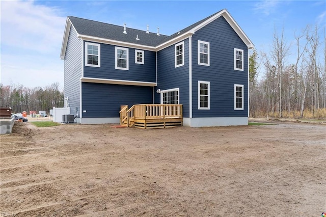 rear view of property with central AC and a deck