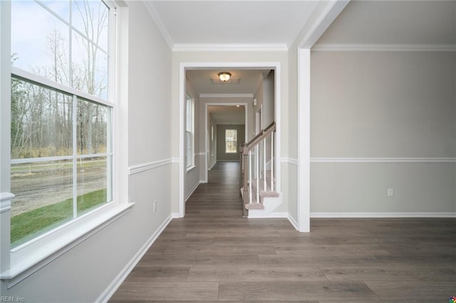 hallway featuring stairway, baseboards, wood finished floors, and ornamental molding