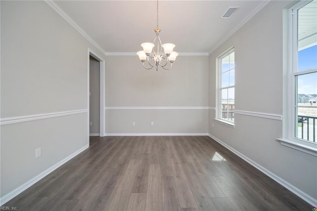 unfurnished dining area with a healthy amount of sunlight, wood finished floors, a chandelier, and visible vents