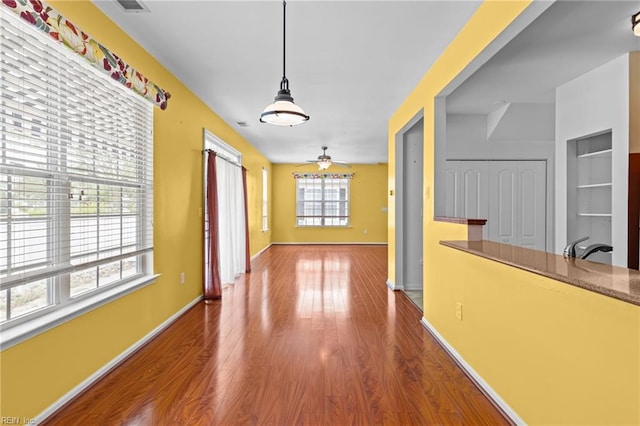 hall with wood finished floors and baseboards