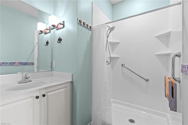 full bathroom with vanity and a stall shower