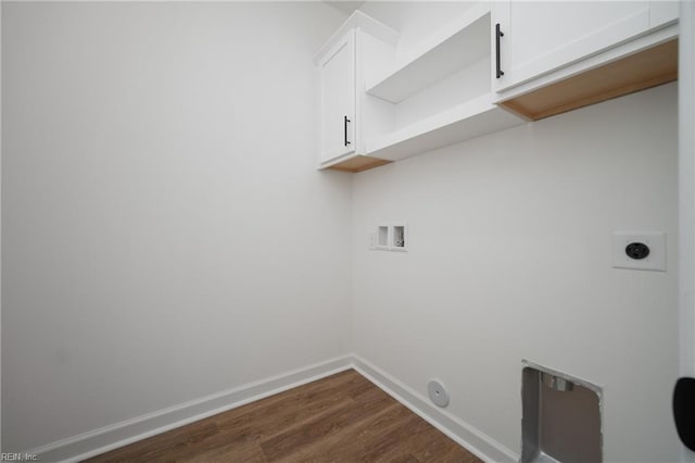 clothes washing area featuring hookup for an electric dryer, dark wood-style flooring, baseboards, washer hookup, and cabinet space