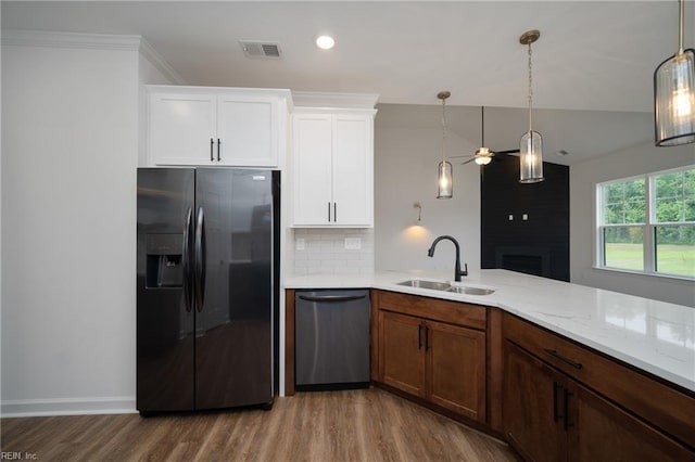 kitchen featuring dishwasher, visible vents, a sink, black refrigerator with ice dispenser, and ceiling fan