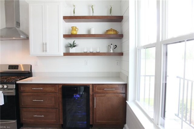 2229 Captiva Ln, Chesapeake, VA 23321 - bar featuring stainless steel range with gas cooktop, beverage cooler, a bar, and wall chimney range hood