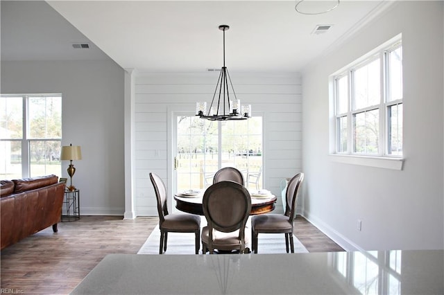 2229 Captiva Ln, Chesapeake, VA 23321 - dining area featuring baseboards, wood finished floors, visible vents, and an inviting chandelier