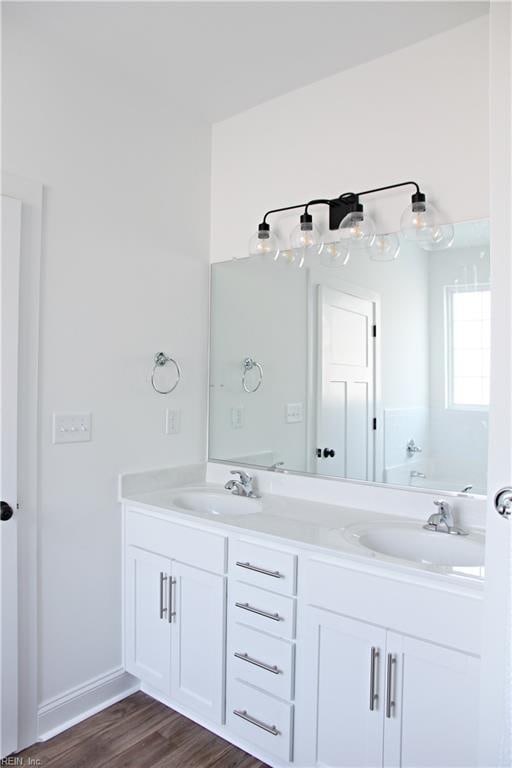 2229 Captiva Ln, Chesapeake, VA 23321 - full bath featuring double vanity, a bathing tub, wood finished floors, and a sink