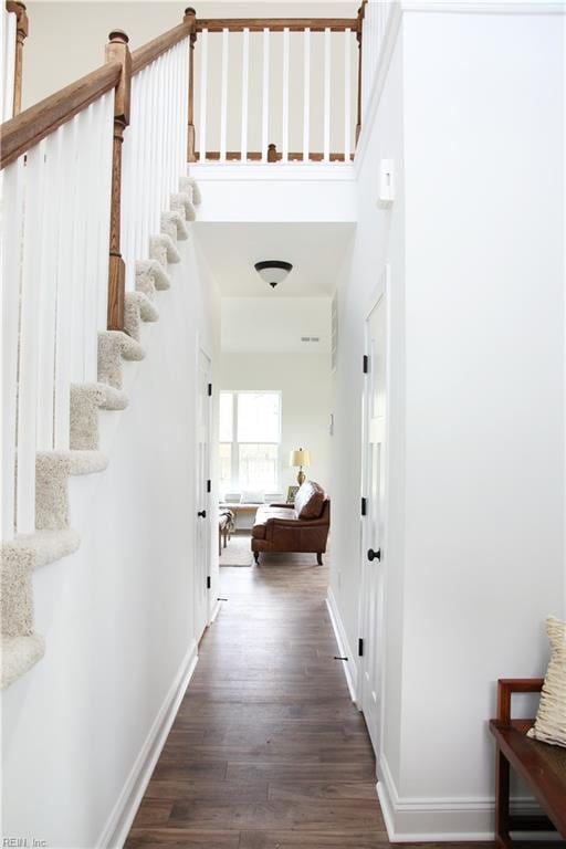 2229 Captiva Ln, Chesapeake, VA 23321 - hall with dark wood finished floors, stairs, baseboards, and a high ceiling