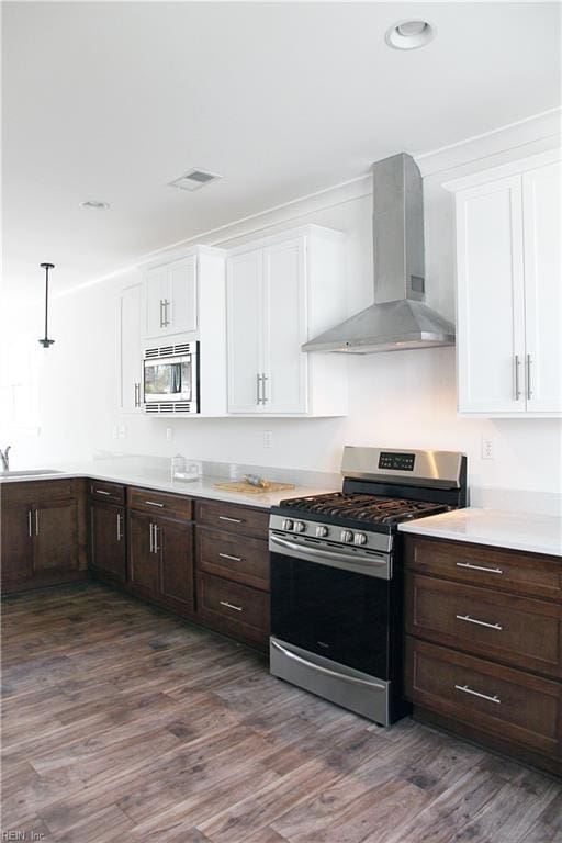 2229 Captiva Ln, Chesapeake, VA 23321 - kitchen featuring wall chimney range hood, a sink, dark wood-type flooring, appliances with stainless steel finishes, and white cabinetry