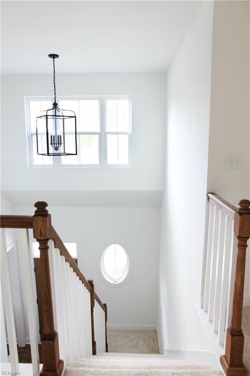 2229 Captiva Ln, Chesapeake, VA 23321 - stairway featuring baseboards and a notable chandelier