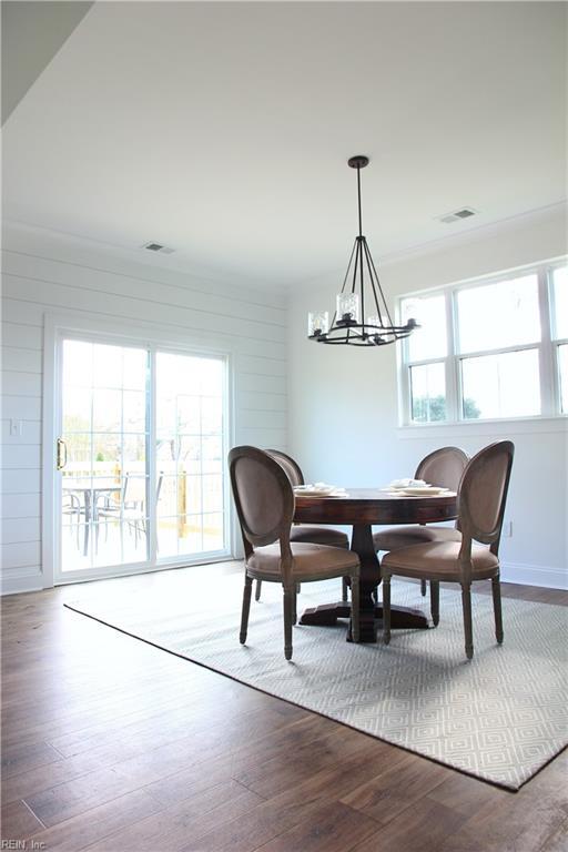 2229 Captiva Ln, Chesapeake, VA 23321 - dining room with a notable chandelier, wood finished floors, and visible vents