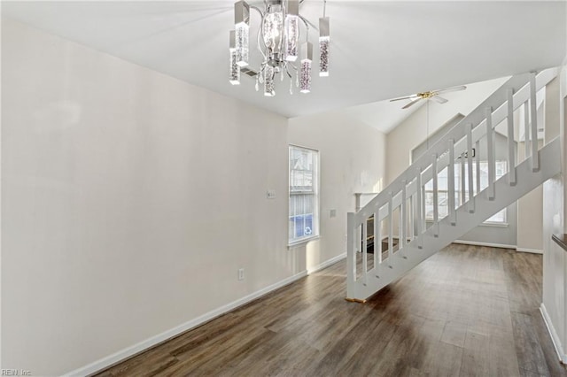 interior space with stairway, baseboards, wood finished floors, and ceiling fan with notable chandelier