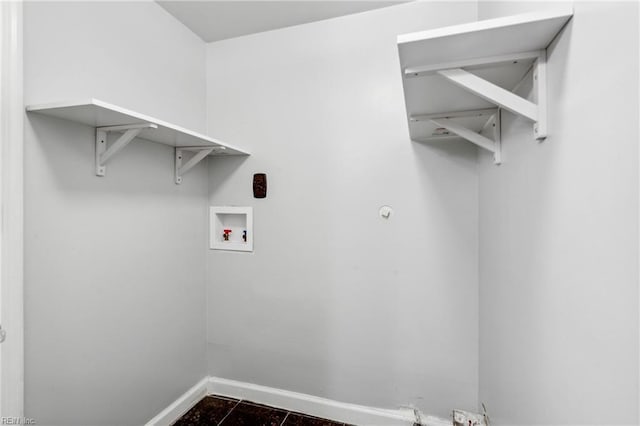washroom with baseboards, hookup for a washing machine, and laundry area