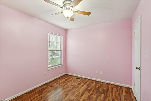 unfurnished room featuring ceiling fan, baseboards, wood finished floors, and visible vents