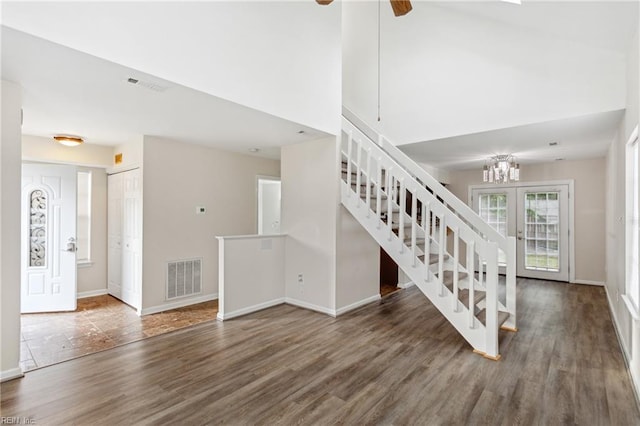 stairs featuring baseboards, wood finished floors, visible vents, and ceiling fan