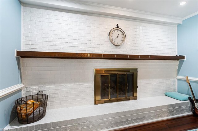 room details featuring a brick fireplace and ornamental molding