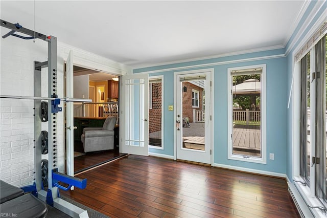 entryway featuring hardwood / wood-style flooring, baseboards, a baseboard radiator, and crown molding