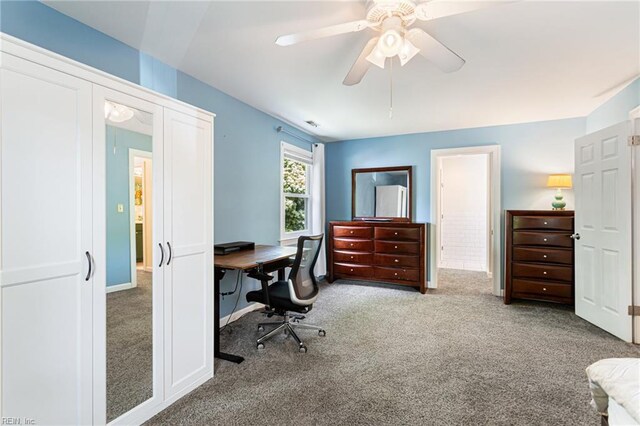 carpeted home office featuring a ceiling fan