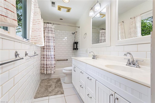full bath with tile walls, visible vents, tile patterned flooring, and a sink