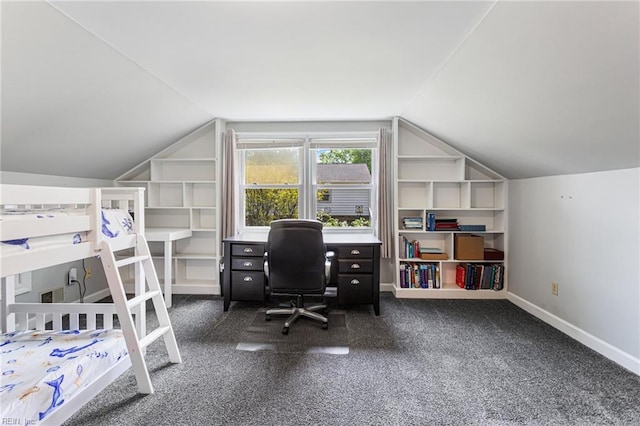 bedroom featuring dark carpet, lofted ceiling, and baseboards