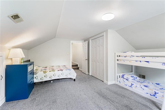 bedroom featuring vaulted ceiling, baseboards, visible vents, a closet, and carpet floors