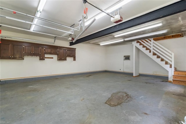 garage featuring a garage door opener and baseboards