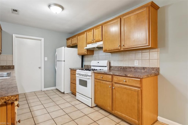 kitchen with decorative backsplash, under cabinet range hood, visible vents, and white appliances