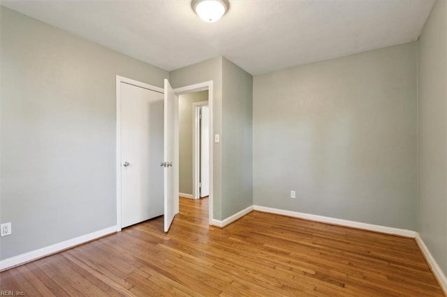 unfurnished bedroom featuring baseboards and light wood finished floors