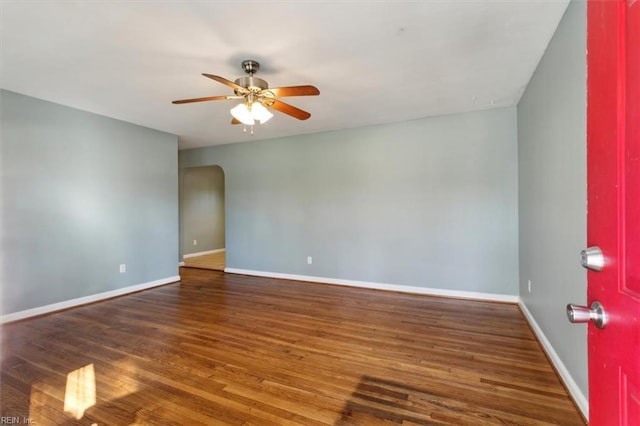 unfurnished room featuring wood finished floors, baseboards, and ceiling fan