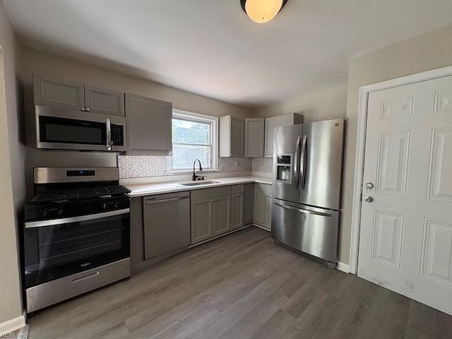 1839 Brookwood Rd, Norfolk, VA 23518 - kitchen featuring a sink, light wood-type flooring, gray cabinets, light countertops, and appliances with stainless steel finishes