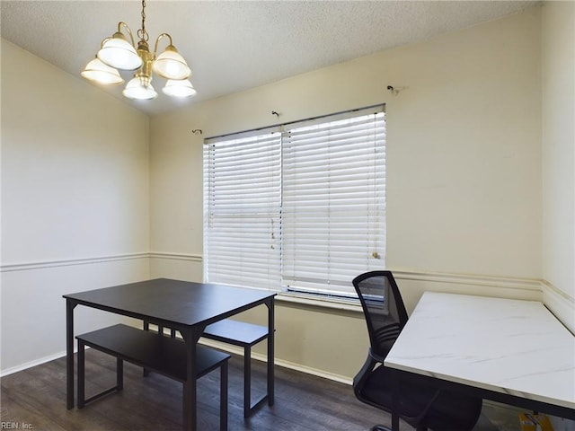 office space featuring an inviting chandelier, dark wood-type flooring, a textured ceiling, and baseboards