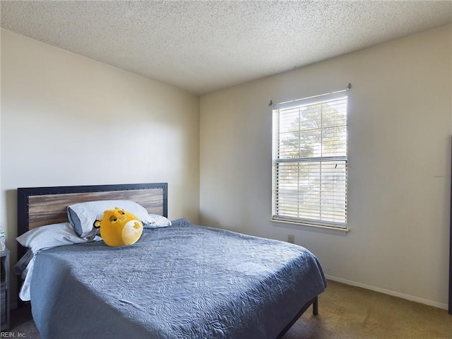 carpeted bedroom featuring a textured ceiling and baseboards