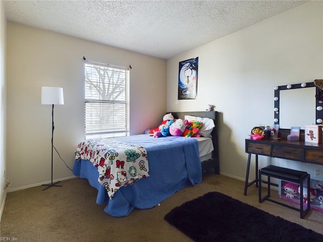 bedroom with baseboards, a textured ceiling, and carpet