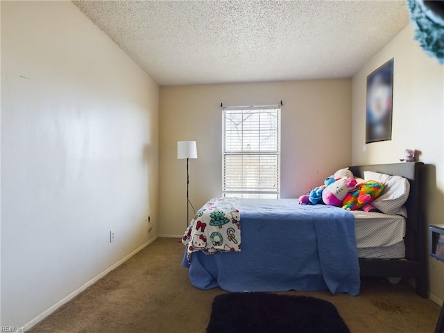 carpeted bedroom featuring baseboards and a textured ceiling