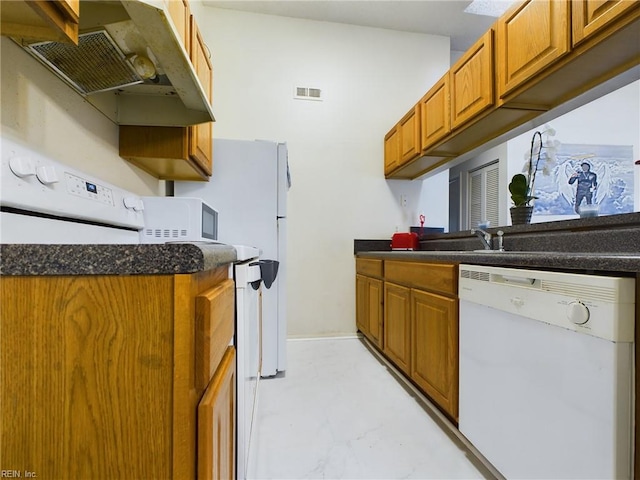 kitchen with brown cabinets, dark countertops, visible vents, white dishwasher, and under cabinet range hood