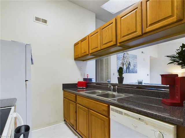 kitchen with a sink, brown cabinets, range, visible vents, and dishwasher