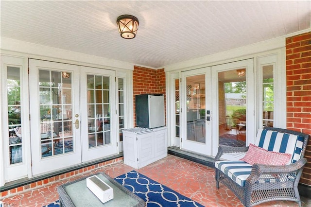 sunroom / solarium featuring french doors