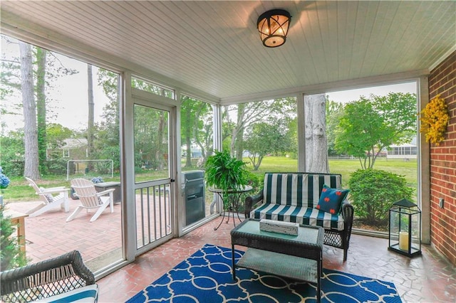 sunroom featuring an outdoor hangout area and a healthy amount of sunlight