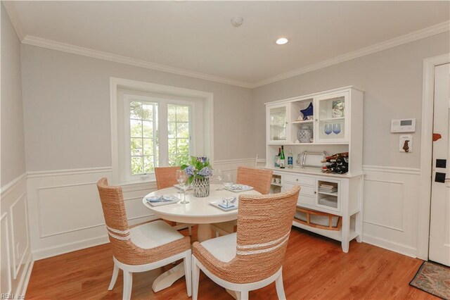 dining area with a decorative wall and wainscoting