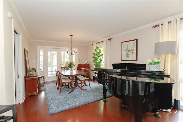 living area with wood finished floors, crown molding, and a notable chandelier