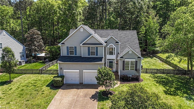 3733 Captain Wynne Dr, Williamsburg, VA 23185 - view of front of house featuring a garage, fence, a front yard, central AC unit, and driveway