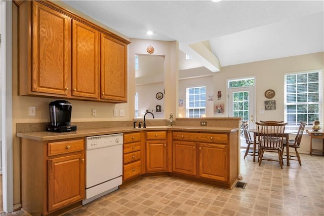 3733 Captain Wynne Dr, Williamsburg, VA 23185 - kitchen with a peninsula, light countertops, brown cabinets, a sink, and dishwasher