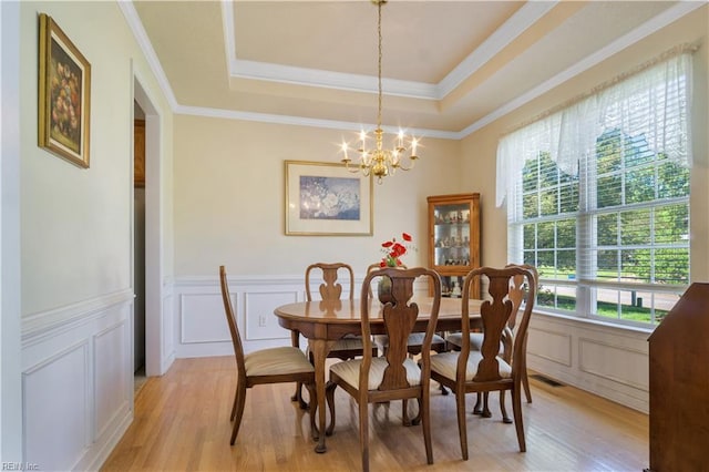 3733 Captain Wynne Dr, Williamsburg, VA 23185 - dining room featuring an inviting chandelier, light wood finished floors, a decorative wall, visible vents, and ornamental molding