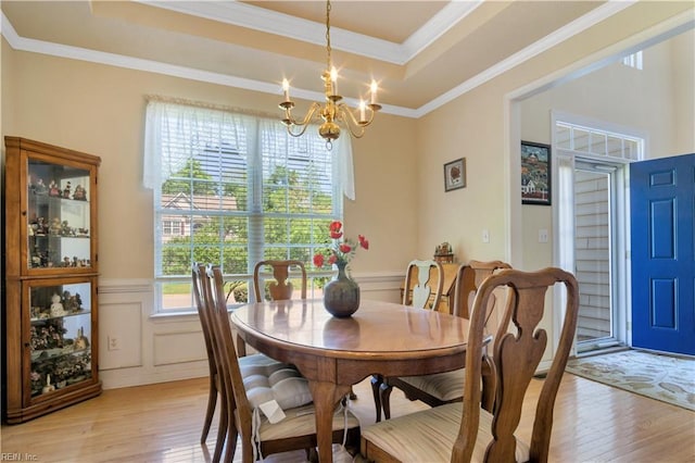 3733 Captain Wynne Dr, Williamsburg, VA 23185 - dining space with wainscoting, a raised ceiling, a chandelier, light wood-type flooring, and ornamental molding