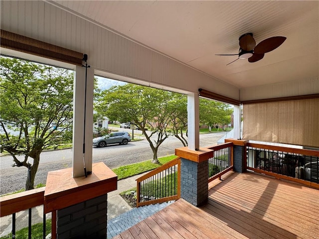 wooden terrace with covered porch and ceiling fan