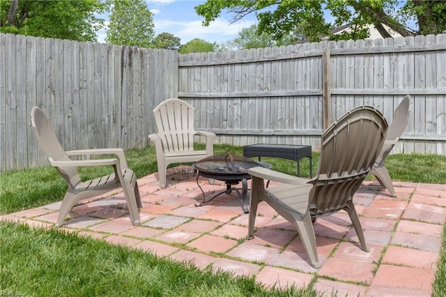 view of patio with fence private yard and an outdoor fire pit